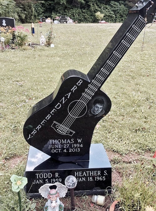 upright headstone in the shape of a guitar