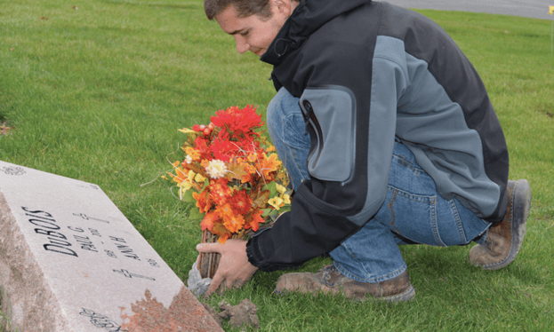 Michael Placing Flowers in an In-Ground Vase