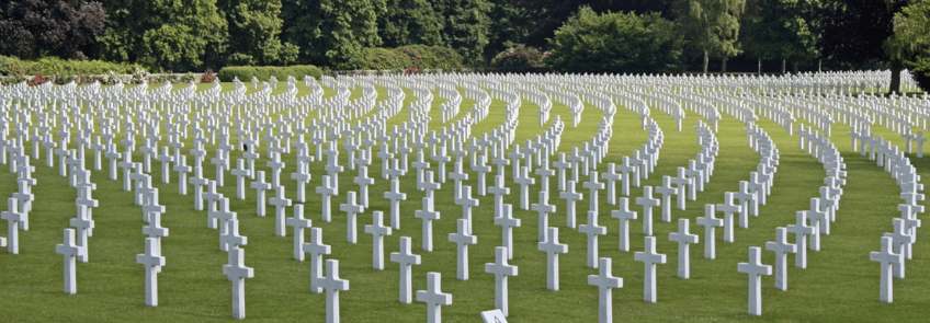 cemetery with straight rows of white cross memorials grave markers